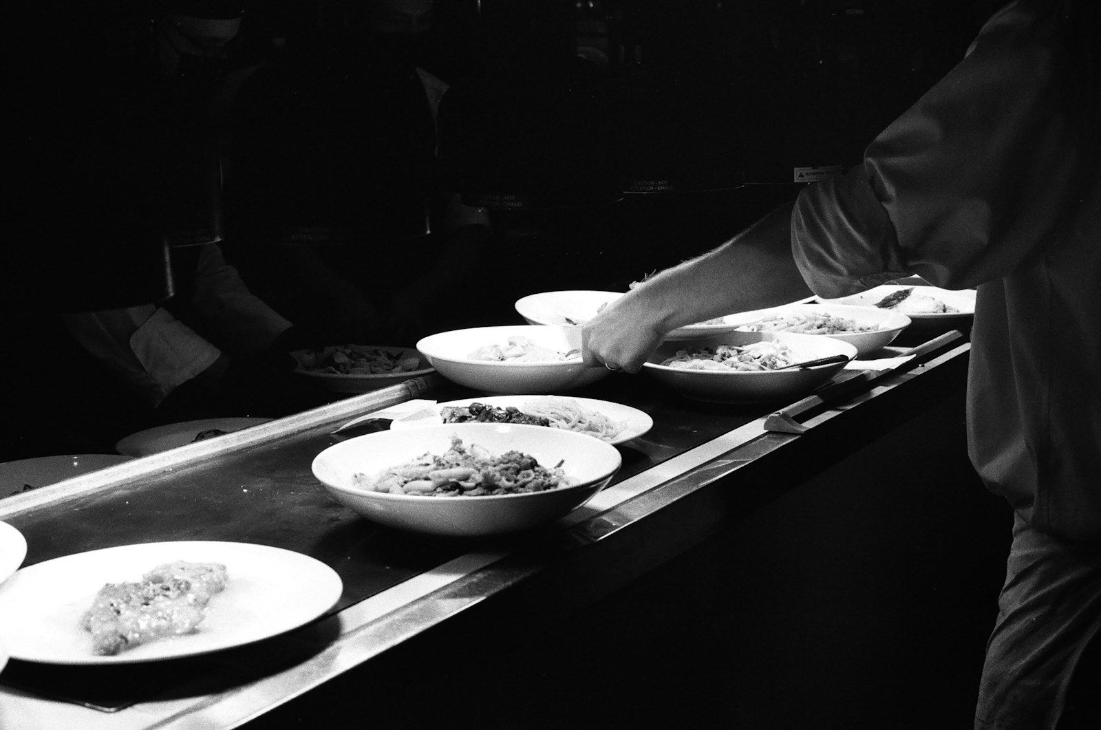 A chef carefully plating a dinner